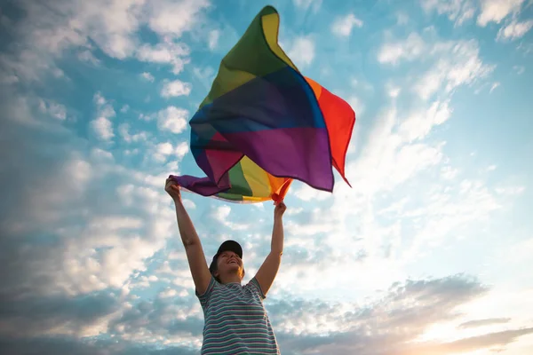 Woman holding a Gay Rainbow Flag.Happiness, freedom and love concept for same sex couples