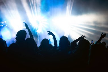 Konserde kalabalık - Parlak renkli sahne ışıkları önünde tezahürat yapan kalabalık