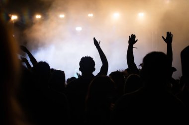 Konserde kalabalık - Parlak renkli sahne ışıkları önünde tezahürat yapan kalabalık