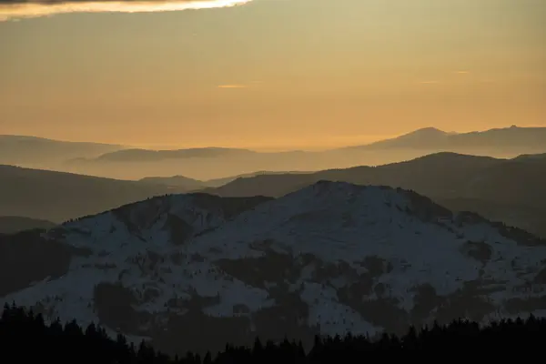 Winter landscape in magic sunset in Ceahlau mountain, Romania.