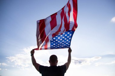 Man holding american USA flag. Independence Day or traveling in America concept. 