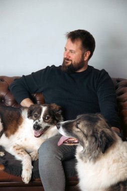 Evinde sevimli, mutlu köpekleri olan beyaz yakışıklı bir adam..