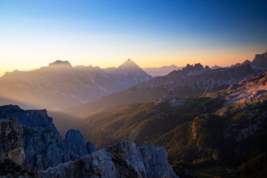 Sunset light games on the Dolomite mountains highest peaks seen from Rifugio Lagazuoi, on a spectacular summer morning clipart