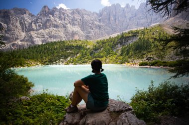 İtalya 'nın Dolomitler şehrinde turkuaz Lago di Sorapiss 1.925 metre irtifa (dağ gölü) manzarasının keyfini çıkaran kadın.