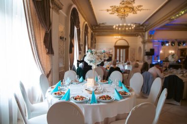 Düğün resepsiyonunda vazo dolusu çiçekle süslenmiş yemekler ve içecekler.