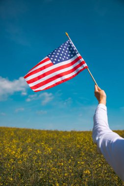 Amerikan bayrağı tutan genç bir kadın. Bağımsızlık Günü ya da Amerika 'da seyahat. 