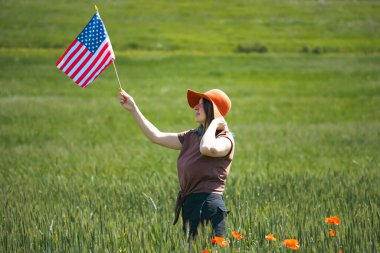 Amerikan bayrağı tutan genç bir kadın. Bağımsızlık Günü ya da Amerika 'da seyahat. 