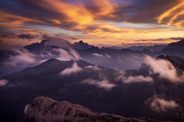 Dolomite dağlarında gün batımı oyunları ve sis Rifugio Lagazuoi 'nin en yüksek tepelerinde görüldü. Muhteşem bir yaz günbatımında..