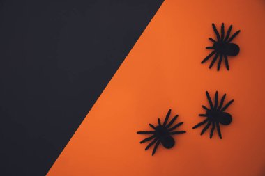 Halloween flat lay composition on orange background with copy space.