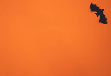 Halloween flat lay composition on orange background with copy space.