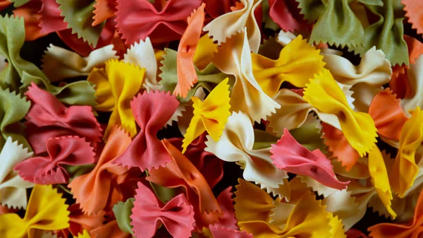 stock image Freeze motion of flying uncooked italian pasta farfalle on black background