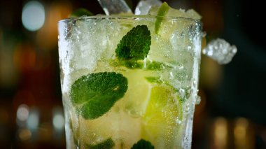 Mojito cocktail on the bar, dark toned background