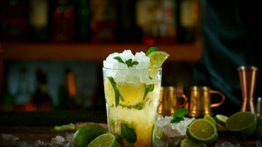 Mojito cocktail on the bar, dark toned background