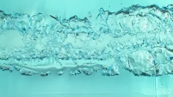 Super Slow Motion Splashing Water Surface Light Blue Background Filmed — Stock Video