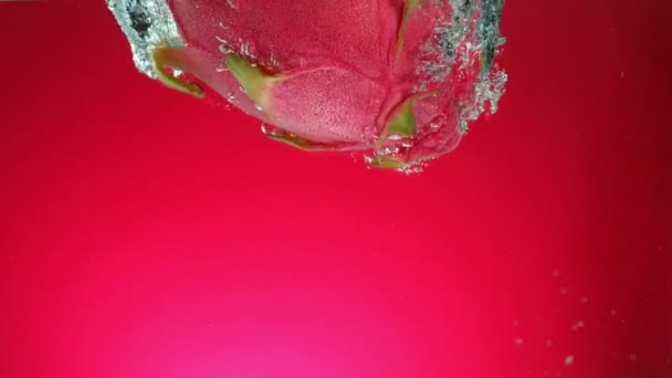 Super Slow Motion Falling Fresh Pitahaya Water Red Gradient Background — Stock Video