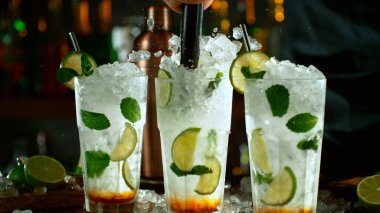 Close-up of preparing mojito cocktail on a bar