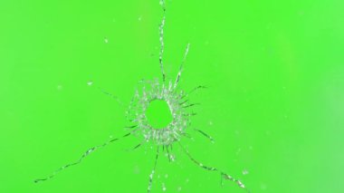 Camdan giren silah sesi çok yavaş, yeşil ekran arka planına çarpıyor. Yüksek hızlı sinema kamerası, 1000 fps..