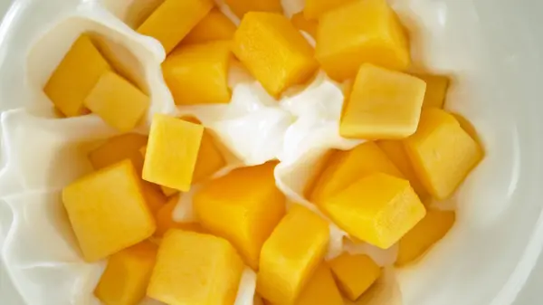 Fresh Mango Pieces Falling Yoghurt Cream Top View Stock Picture