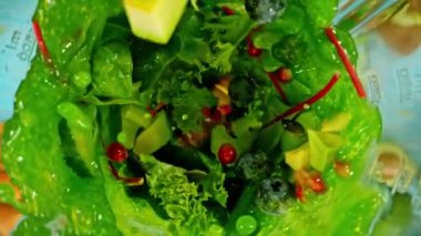 Meyve ve sebzeleri blender 'da karıştırmanın süper yavaş çekimi, kamera hareketi, üst çekim. Yüksek hızlı sinema kamerası, 1000 fps..