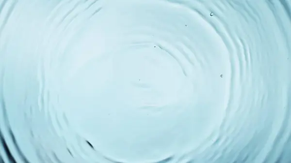 stock image Freeze motion of splashing water drops on on light blue background