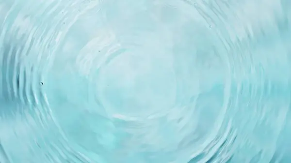 stock image Freeze motion of splashing water drops on on light blue background