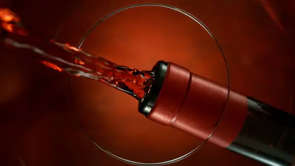 stock image Freeze Motion Shot of Red Wine Pouring, Unique Angle of View from the Bottom of the Glass