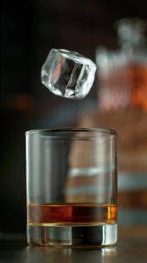 Viskiyi cama dökmenin çok yavaş bir yolu. Yüksek hızlı sinema kamerası, 1000 fps, dikey yönelim