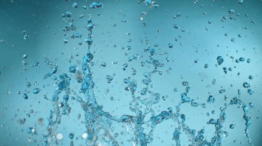 Freeze motion of splashing water on light blue background clipart