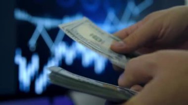 Adamın eli 100 dolarlık banknotları nakit olarak sayıyor. Finans ve yatırım kavramı. Kapat.