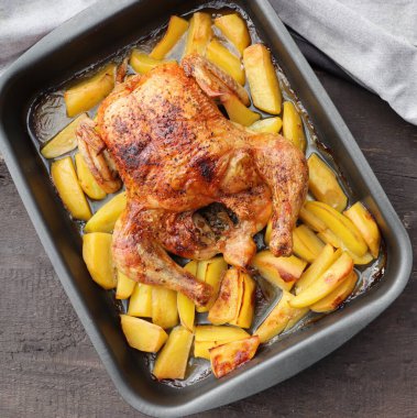 Roasted whole chicken or turkey with potatoes for celebration and holiday. Christmas, thanksgiving, new year's eve dinner .