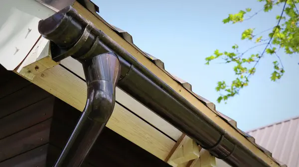Rain Gutter Pipeline System Installation. Roofing Construction. Rain gutter system and roof protection from snow . Home Guttering, Gutters, Guttering , Drainage Pipe Exterior.