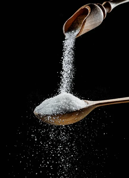 White Refined Sugar Crystals Falling Wooden Spoon Black Background — Photo