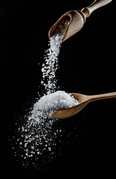 Edible Salt Crystals Falling Wooden Spoon Black Background — Stock Photo, Image