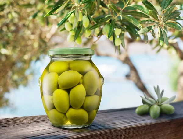 Whole Green Olives Cured Brine Glass Can Wooden Plank Blurred — Stock Photo, Image