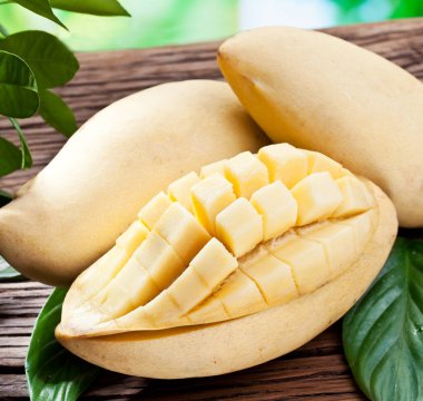 Mango - tropical fruit on wooden table close-up. Nature background.