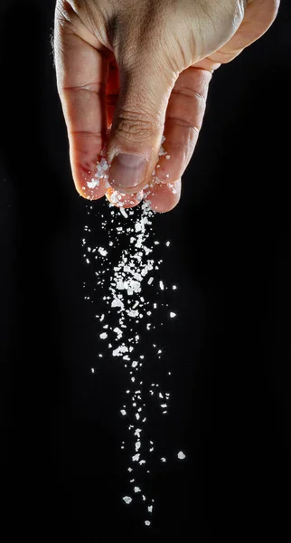 Male Hand Sprinkling Edible Salt Black Background — Stock Photo, Image