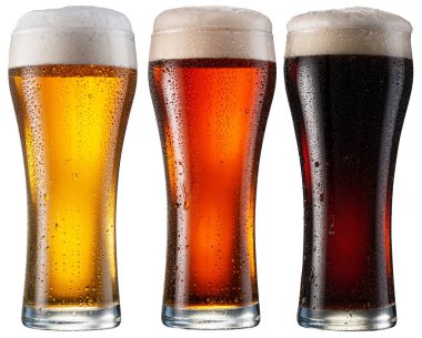 Three chilled glasses of different beer . File contains clipping paths.
