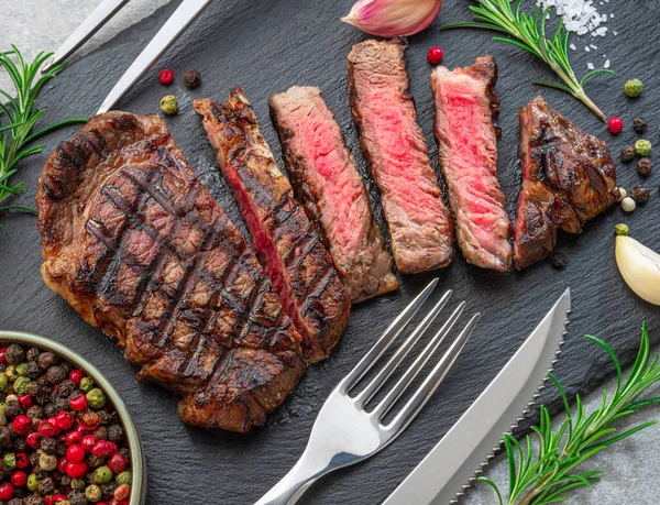 Grilled Delicious Ribeye Steak Slices Some Seasonings Black Slate Serving — Photo