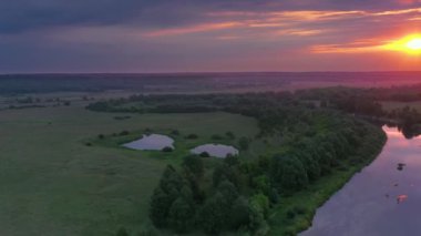 Beautiful aerial view video from a drone of Ukrainian nature - Seim river, morning sun in the mist on the river with trees and open spaces.
