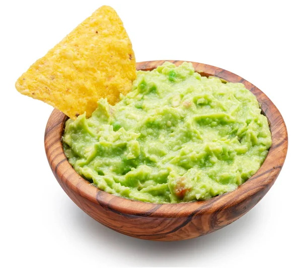 stock image Guacamole bowl and corn chips dipped in it on white background. Top view. File contains clipping path.