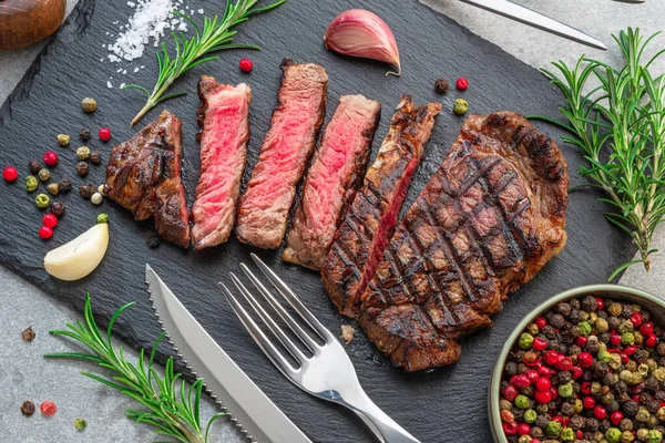 Grilled Delicious Ribeye Steak Slices Some Seasonings Black Slate Serving — Stock fotografie