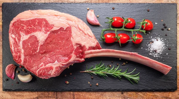 Raw Rib Steak Bone Tomahawk Steak Seasonings Slate Serving Plate — Stock Photo, Image
