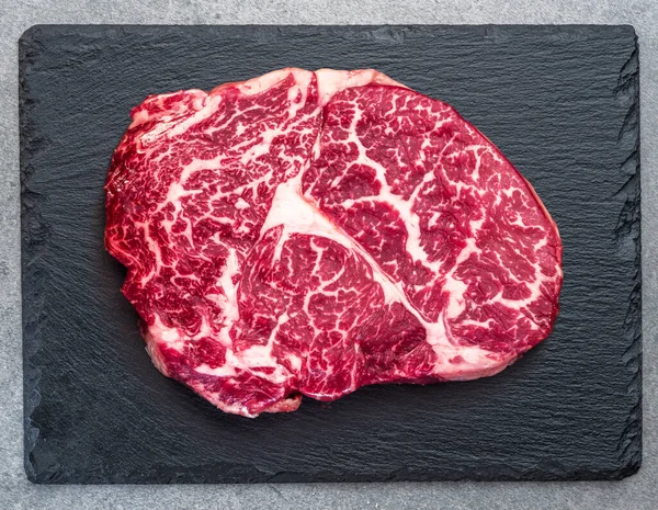 Raw Ribeye Steak Stone Black Serving Plate Flat Lay — Stock fotografie