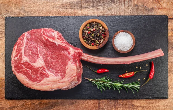 Raw Rib Steak Bone Tomahawk Steak Seasonings Slate Serving Plate — Stock Photo, Image