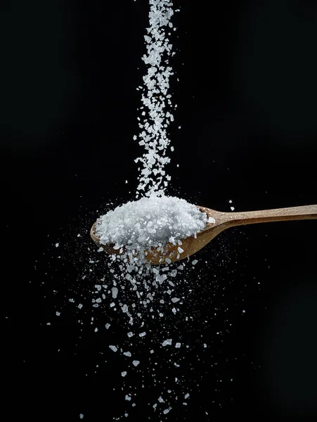 Edible Salt Crystals Falling Wooden Spoon Black Background — Stock Photo, Image