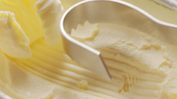 バターはバターのパックから認識可能な形に特別なバターナイフで切り取られます — ストック動画