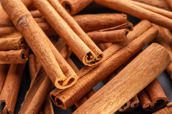 Cinnamon sticks against the background of a gray stone table. Nice spices cinnamon background for your projects.