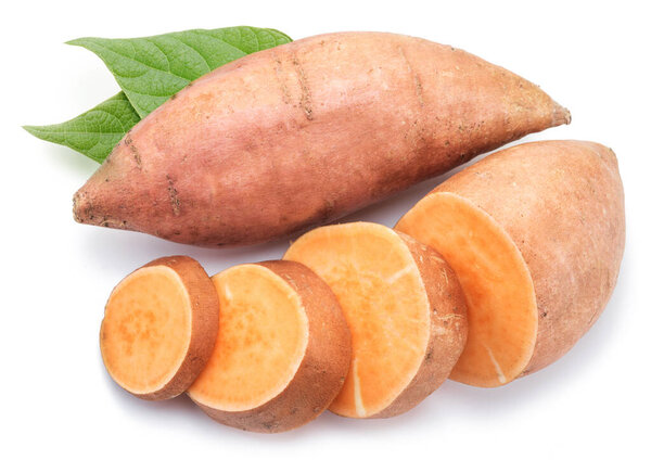 Sweet potatoes with sweet potato slices and batata leaves isolated on a white background.