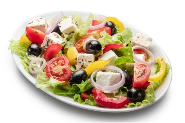 Greek salad on white plate isolated on white background. File contains clipping path. clipart