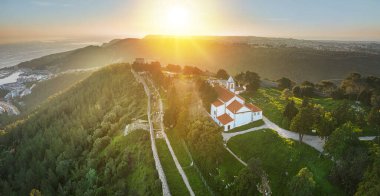 Drone aerial view on Castle of Sesimbra, national monument in Setubal district in Portugal. clipart
